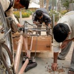 Sewa Ashram has also been able to obtain a few tricycles, which patients use to sell products at the roadside. Here, staffers finish assembling a trike.